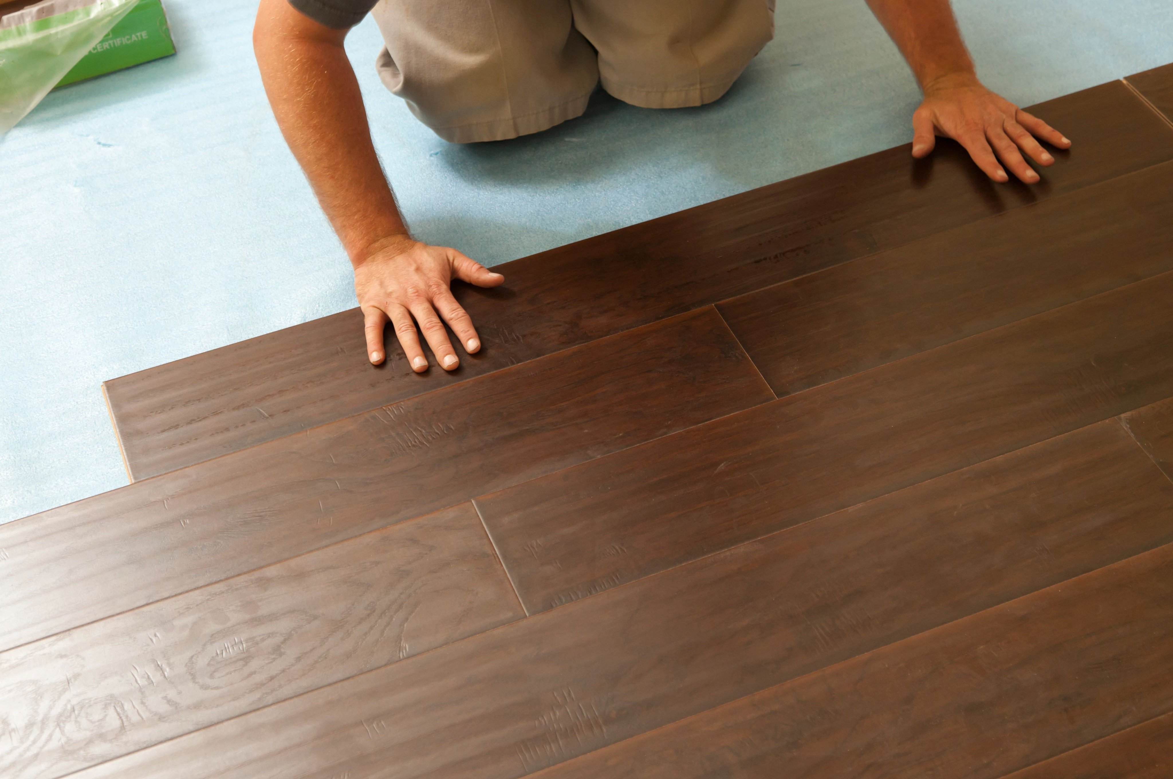 Person installing hardwood flooring from Korfhage Floor Covering in the Louisville, KY area