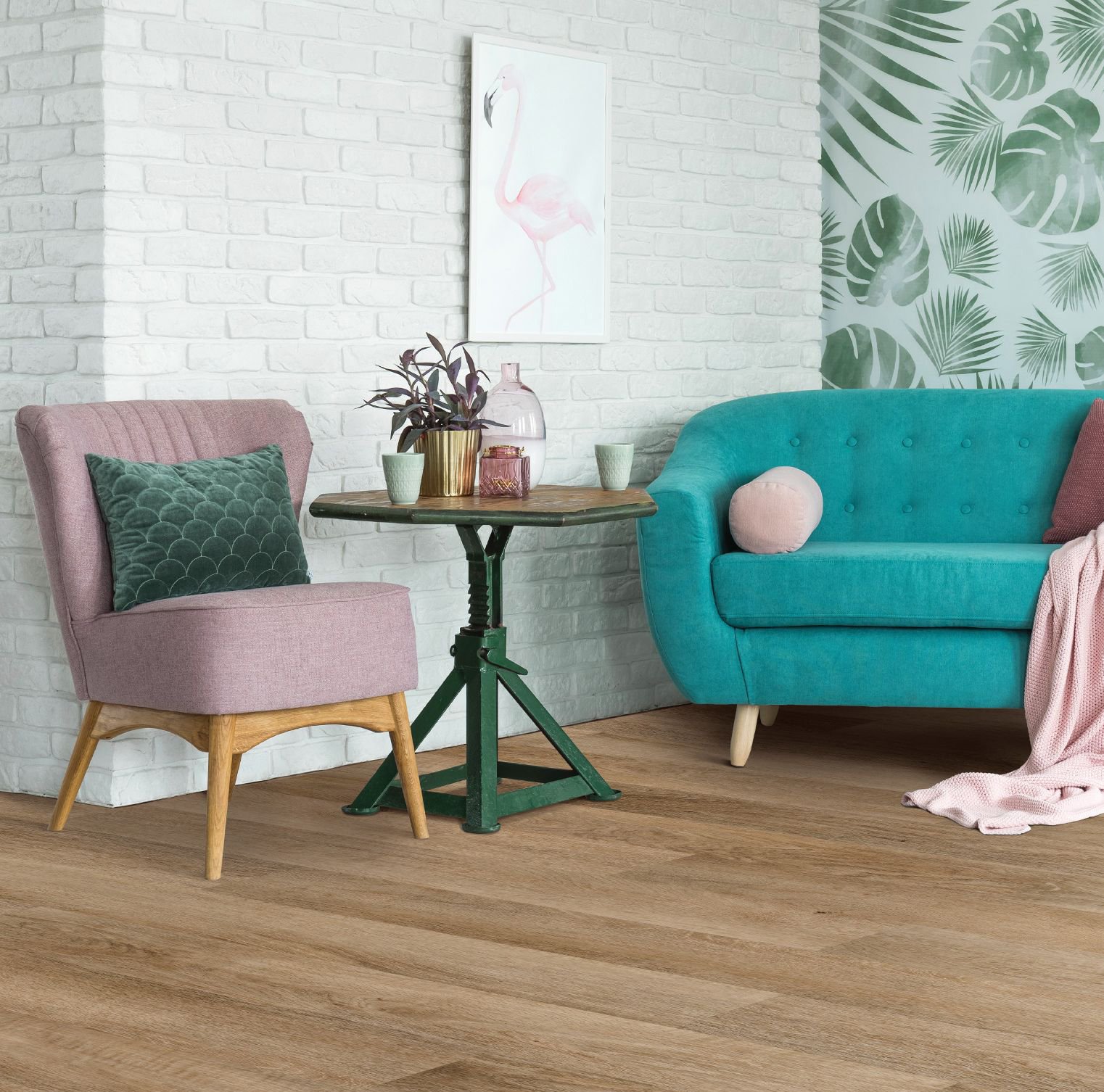 Teal couch and pink armchair in living room with wood-look luxury vinyl flooring from Korfhage Floor Covering in the Louisville, KY area